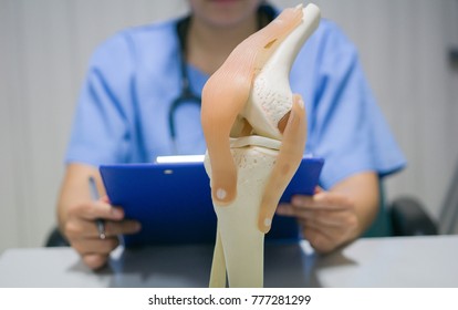 An Orthopedic Surgeon Reads A Patient's Knee Replacement Report For Analysis And Guidelines For Postoperative Treatment And Allows The Patient To Live A Normal Life. Medical And Orthopedic Concept.