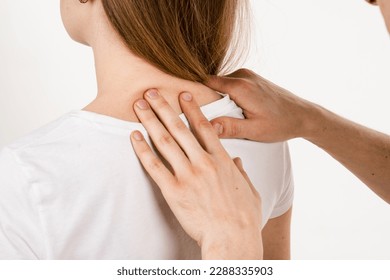 Orthopedic traumatologist examines head and neck of patient and checks mobility of movements on white background. Movement assessment or joint mobilization. Muscle release - Powered by Shutterstock