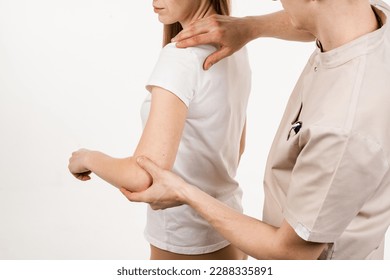 Orthopedic traumatologist examines shoulder joint of patient and checks mobility of movements on white background. Movement assessment or shoulder joint mobilization. Muscle release - Powered by Shutterstock