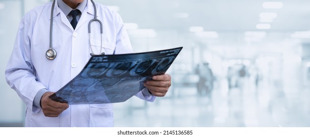 Orthopedics surgeon doctor examining patient's knee joint x-ray films, MRI bone, CT scan in at radiology unit, hospital background. knee joint film x ray, healthcare and medicine concept, close up - Shutterstock ID 2145136585