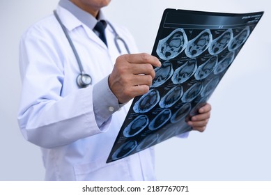 Orthopedics Surgeon Doctor Examining Patient's Knee Joint X-ray Films, MRI Bone, Ct Scan In At Radiology Orthopedic Unit In Hospital. Knee Joint Film X Ray, Close Up