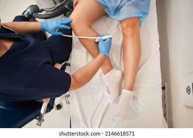 Orthopedist Doctor Doing Ultrasound Examination Of Patient's Leg Veins In His Office