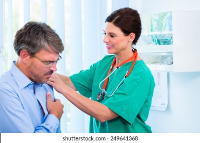 Orthopedist Doctor Examining Shoulder Of Patient In Surgery