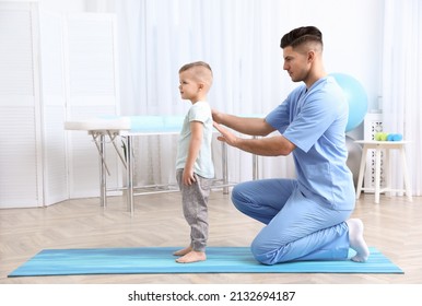 Orthopedist examining child's back in clinic. Scoliosis treatment - Powered by Shutterstock