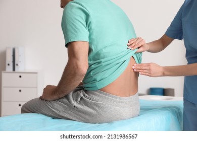 Orthopedist examining man's back in clinic, closeup. Scoliosis treatment - Powered by Shutterstock