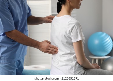 Orthopedist examining woman's back in clinic, closeup. Scoliosis treatment - Shutterstock ID 2123651591