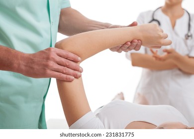 Orthopedist And Orthopedic Surgeon Discussing The Details Of Arm Surgery