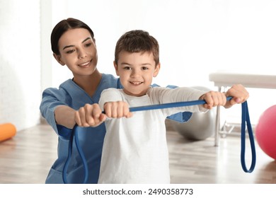 Orthopedist working with little boy in hospital gym - Powered by Shutterstock