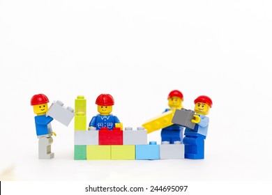 Orvieto, Italy - January 16th 2015: group of workman Lego mini figure build a wall. Lego is a popular line of construction toys manufactured by the Lego Group