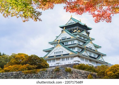 Osaka Castle In Osaka,Kansai,Japan In Fall Or Autumn Season. Maple Tree Are Turn Into Red And Orange Leaf. There Are Red Leaf In Foreground.It Is One Of Most Famous Landmark In Japan