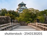 Osaka Castle from the side of the Gokuraku-bashi Bridge over the Inner Moat on a sunny autumn morning, Osaka, Japan