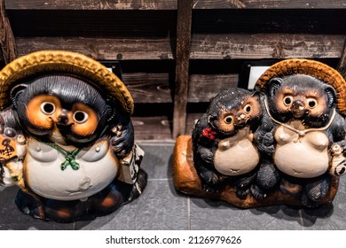 Osaka, Japan - April 13, 2019: Osaka, Japan City Street At Night With Statues Sculptures Decoration Of Tanuki, A Japanese Racoon Dog In Traditional Folklore