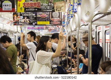 OSAKA, JAPAN - AUGUST 4, 2015: People Travels In The Crowded Osaka Subway In Japan Third Largest City In Kansai Province.