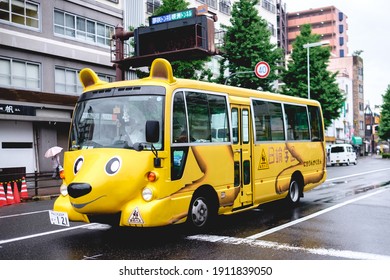 Osaka, Japan - Circa 2015: School Bus With Form Of Yellow Dog In The Streets In A Rainy Day