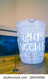 OSAKA ,JAPAN; JANUARY 2: Giant size of glowing cup noodle at the entrance of Instant Ramen Museum in Osaka on 2 January 2014.