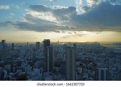 Osaka, Japan - January 9th, 2020: View of sunset in Osaka from Umeda Sky Building. Top view of vertical and dense city of Osaka. - Shutterstock ID 1661307733