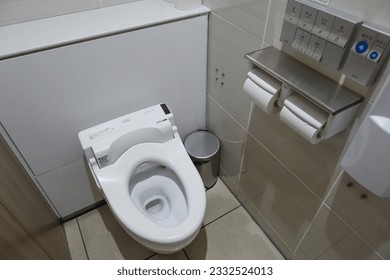 OSAKA, JAPAN - July 17, 2023 : Electronic commands of high-tech Japanese toilets on the wall, functions include bidet sanitizer, front and rear washing, privacy music, Toto brand, close up picture - Shutterstock ID 2332524013