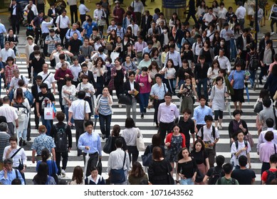 OSAKA, JAPAN- JUNE 21 2017: People cross the street in front of Osaka train station in Osaka, Japan.