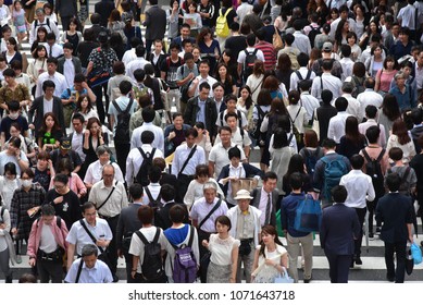 OSAKA, JAPAN- JUNE 21 2017: People cross the street in front of Osaka train station in Osaka, Japan.