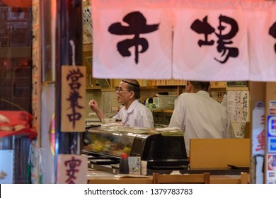 Osaka / Japan - March 19th 2018: Staff at Izakaya restaurant and bar in Dotonbori area in central Osaka. An izakaya is a type of informal Japanese pub popular for after-work drinking