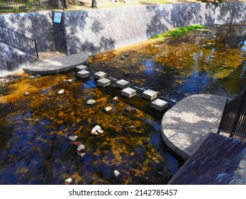 Osaka, Japan, March 30th, 2022: A Row Of Stepping Stones Above The River Used For Crossing.