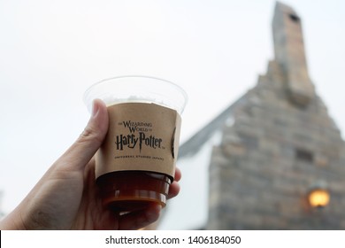 Osaka, Japan - May 24, 2019 : Hand Holding Cup of Butterbeer in Wizarding World at Universal Studio Japan in Osaka