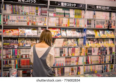 Osaka, JAPAN - May 27, 2017: Young Girl Reading Manga In The Huge Dresser Of A Store