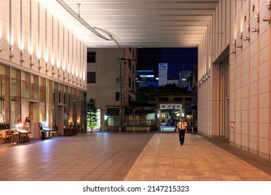 Osaka, Japan - September 25, 2015: Security Officer On Patrol In Large Office Entryway At Night