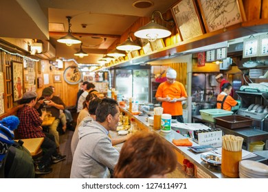 Osaka - Nov. 17, 2018: Unidentified Japanese are seen having meal at local Izakaya or pub in Dotonbori