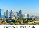 Osaka skyline with Osaka castle, landmark of Osaka city on clear blue sky background.