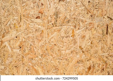 OSB Boards Are Made Of Brown Wood Chips Sanded Into A Wooden Background. Top View Of OSB Wood Veneer Background, Tight, Seamless Surfaces.