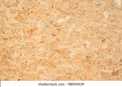 OSB boards are made of brown wood chips sanded into a wooden background. Top view of OSB wood veneer background, tight, seamless surfaces.
 - Shutterstock ID 788594539