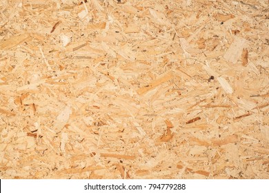 OSB boards are made of brown wood chips sanded into a wooden background. Top view of OSB wood veneer background, tight, seamless surfaces.
 - Shutterstock ID 794779288