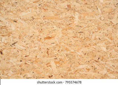 OSB boards are made of brown wood chips sanded into a wooden background. Top view of OSB wood veneer background, tight, seamless surfaces.
 - Shutterstock ID 795574678