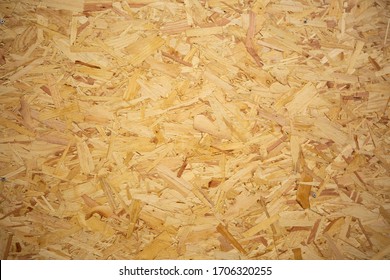 OSB Oriented strand board texture. A type of engineered wood with wooden shavings and particle layers compressed. Brown water-resistant building or furniture material. Strong general purporse board. - Shutterstock ID 1706320255