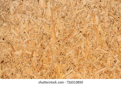 OSB sheet is made of brown wood chips pressed together into a wooden floor. - Shutterstock ID 726513850