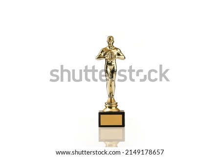 Oscar award or Hollywood golden trophy isolated. The concept of success and victory.