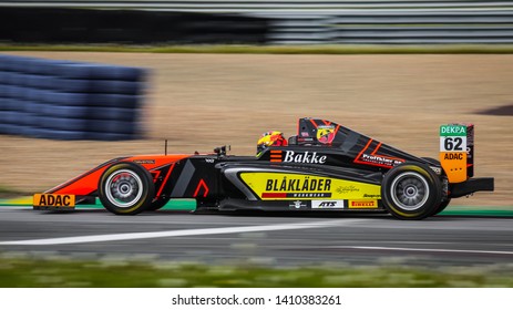 Oschersleben, Germany, April 28, 2019: Male Driver Dennis Hauger Driving A Black Van Amersfoort Racing Single-seater Car During ADAC Formula 4 At The Motorsport Arena Oschersleben.