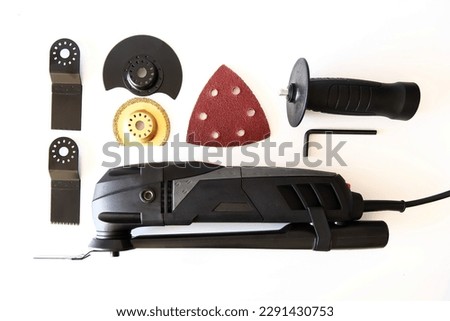 Oscillating Tool Kit on white background. Construction and repair tool with accessories. 