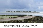 Osea Island, Maldon, Essex, United Kingdom, July 19 2023. Distant view of mysterious retreat, spa and wedding venue in the River Blackwater estuary. With outline of tidal causway. Outdoors, Summer day