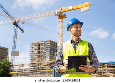 OSHA Inspector At Construction Site. Young Engineer Worker