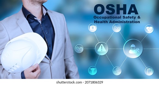 OSHA Occupational Safety And Health Act. The Engineer Holds A White Safety Helmet In His Hands. High Quality Photo