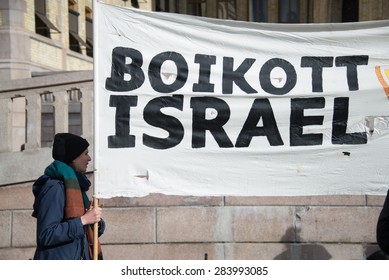 OSLO - MARCH 30: Activists hold a banner reading "Boycott Israel" during a protest in front of the Norwegian Parliament building, Oslo, March 30, 2015. 