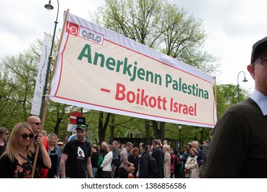 OSLO - MAY 1, 2019: Marchers carry a banner reading "Recognize Palestine - Boycott Israel" during a May Day march in Oslo, Norway, May 1, 2019.