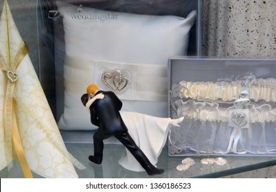 Oslo, Norway -05-10-2014: Wedding Decorations In A Display Window. Funny Wedding Cake Topper. A Romantic Dip Dancing Couple