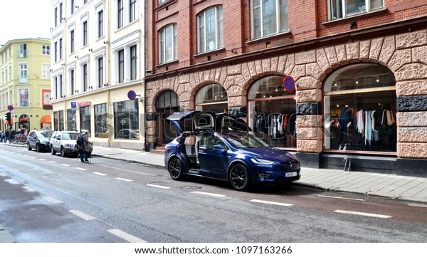 Oslo, Norway\
-05-11-2018: Tesla Model X with falcon wing doors open parked on\
the street. Norway is Tesla\'s biggest market per capita and it\
shows no sign of slowing\
down