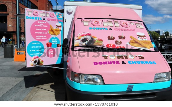 Oslo, Norway -05-12-2019:\
Food truck serving donuts and churros in the Oslo harbor. Mobile\
kitchen, or catering can be performed using food trucks and\
trailers. \
