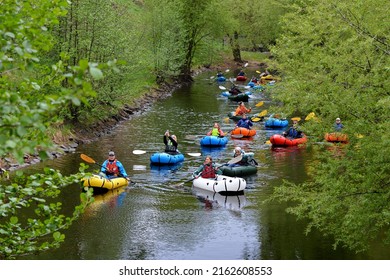 Oslo, Norway -05-13-2022: Group of people canoeing on Akerselva River Tour in spring. Guided paddling adventure, Kit hire included – kayak or SUP, life vest, paddle and helmet