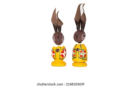 Oslo, Norway - Apr. 19th 2022: Cute decorated, wooden and hand painted Easter bunnies in yellow colors and with long tall ears.