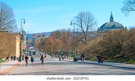 OSLO, NORWAY - APRIL 12, 2010: Street Karl Johans Gate In The Center Of Capital. It Is A Main Street Of The City. Young People Near University Of Oslo. On The Right Is Fragment Of The National Theater